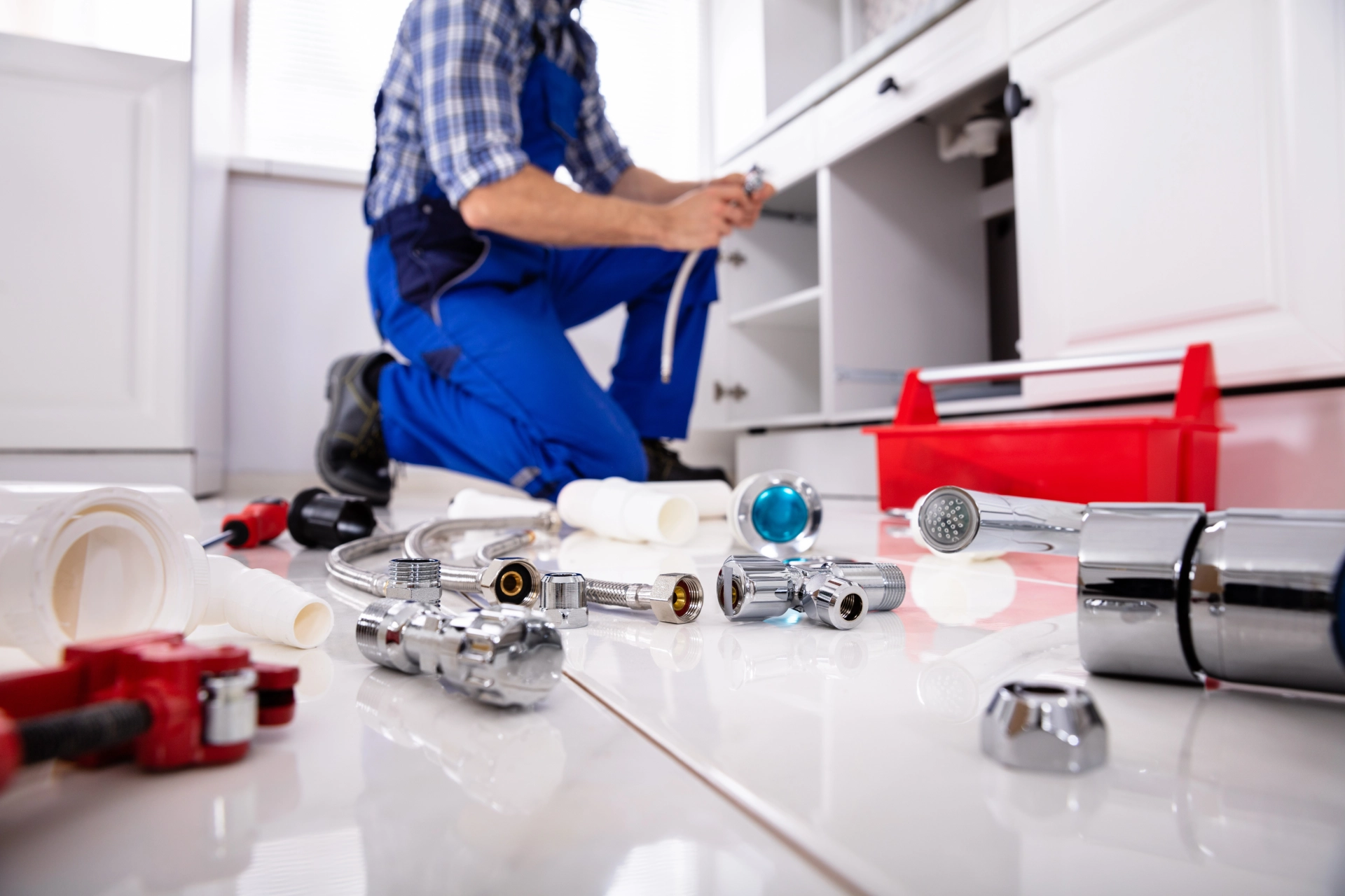 Plumber working in a kitchen